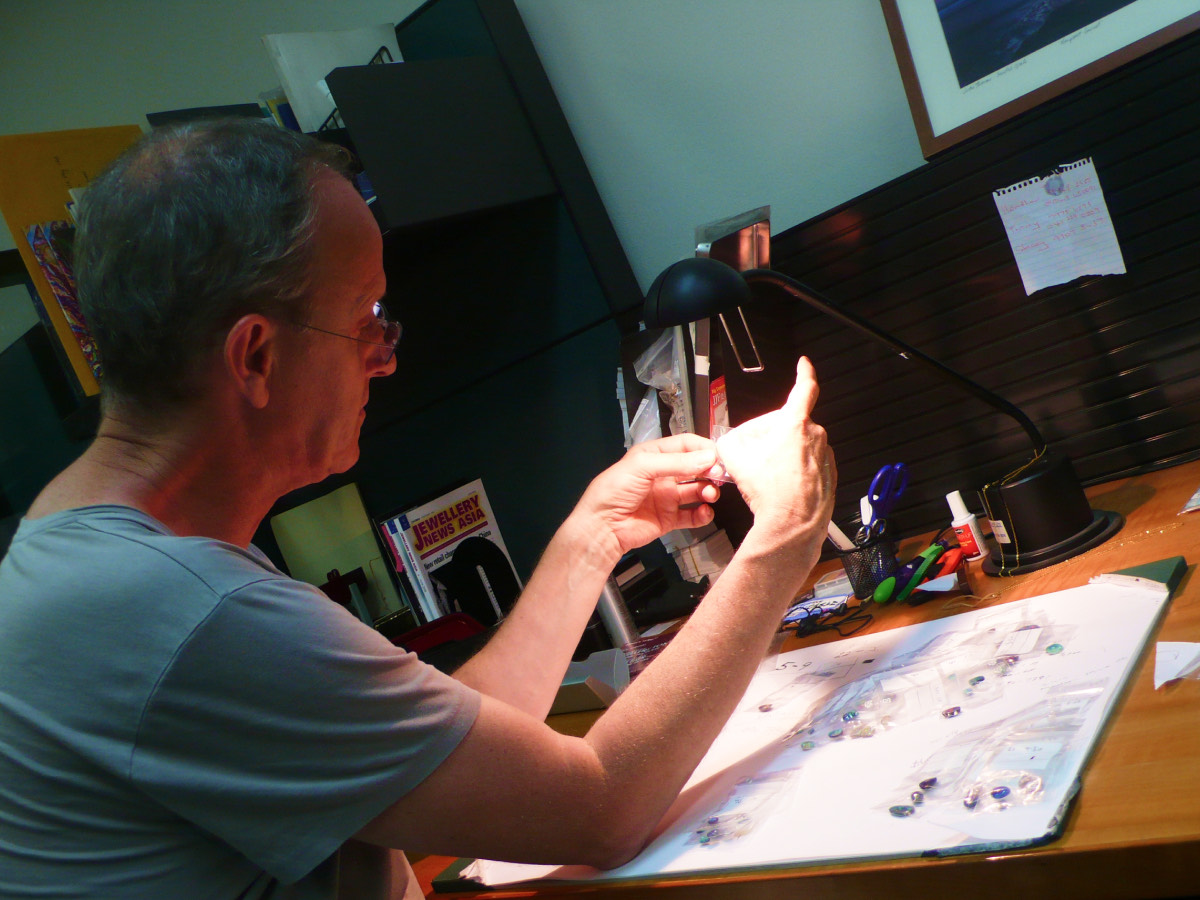 Bruce Harding selecting gemstones at the design desk
